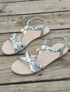 Women's Braided Flat Sandals with Floral Charm Details