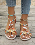 Women's Braided Flat Sandals with Floral Charm Details
